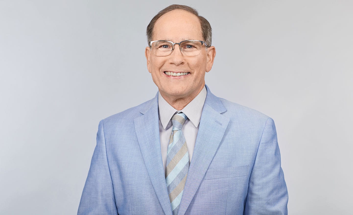 Access-Sciences-Chemical-Industry-SME-Michael-Boses A middle-aged man in glasses and business attire smiles against a light gray background.