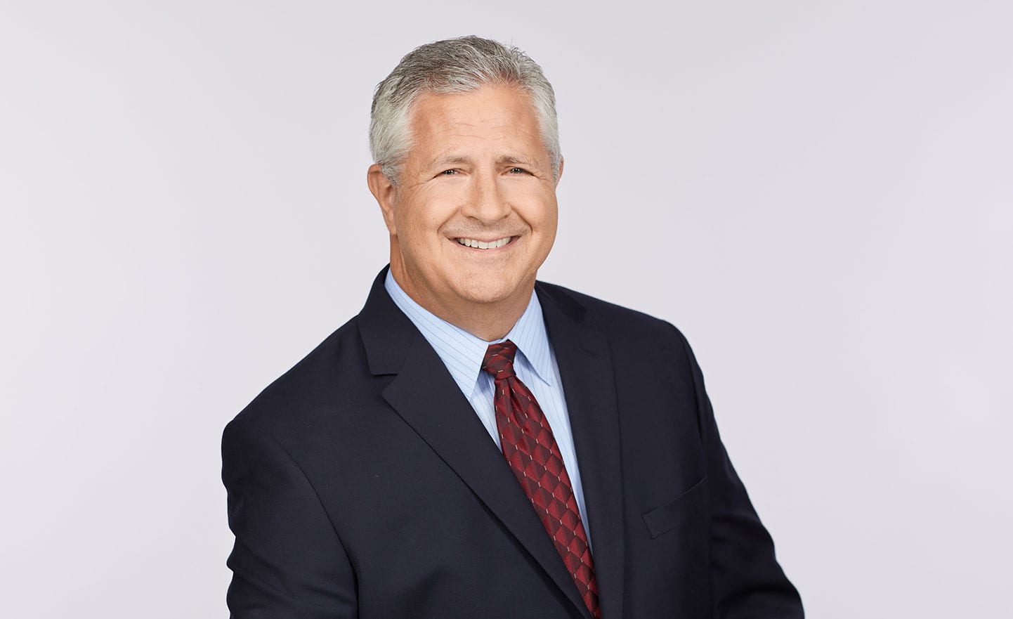 Access-Sciences-Leadership-Steve-Erickson Portrait of Access Sciences' CEO Steve Erickson in a dark suit and red tie.