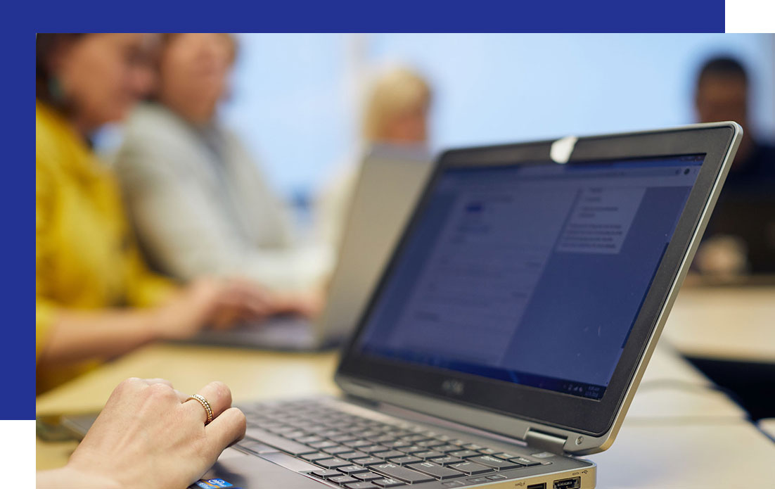 Access-Sciences-What-We-Do-Change-Management-FAQ Close-up of hands typing on a laptop, suggesting a change management setting.