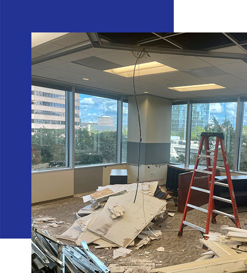 Access-Sciences-Houston-Office-Top-Workplaces A red ladder, debris, and exposed wiring hint at workplace transformation in a high-rise office with city views.