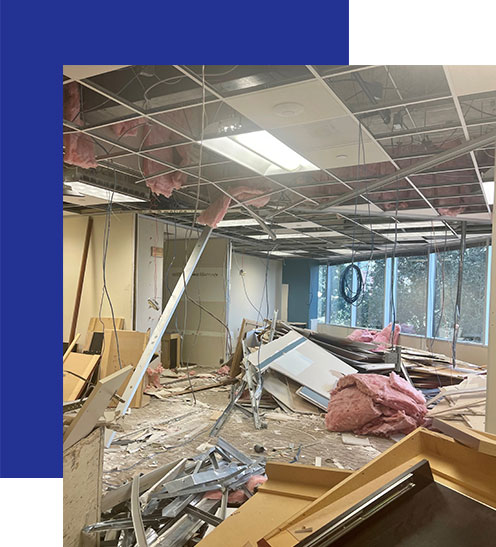 Access-Sciences-Houston-Office An office space with a collapsed ceiling, exposed wiring, and scattered debris.