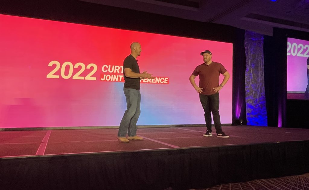 Access Sciences CURT-CII 2022: Three Themes of the New Construction Industry Two men discuss construction sustainability onstage, with "2022 CURT JOINT CONFERENCE" displayed behind them.