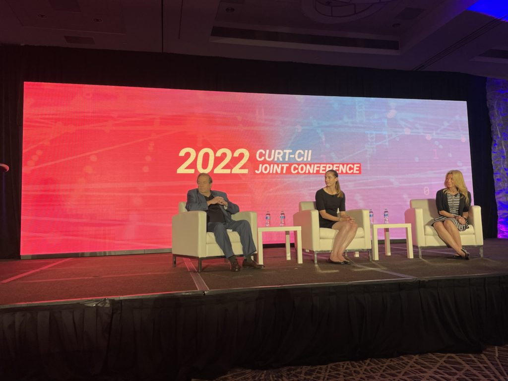 Access Sciences Blog CURT-CII 2022: Three Themes of the New Construction Industry Three people sit onstage, discussing key construction issues, with "2022 CURT-CII Joint Conference" displayed behind them.